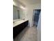 Bathroom features a double sink vanity, tiled floors, and glass shower at 14883 E Crestridge Dr, Centennial, CO 80015