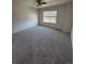 Large carpeted bedroom with a ceiling fan and a bright window letting in natural light at 14883 E Crestridge Dr, Centennial, CO 80015