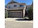 Charming two-story townhome with a stone facade and attached garage at 14883 E Crestridge Dr, Centennial, CO 80015
