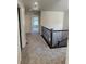 Upstairs hallway with carpet and a staircase with iron railings at 14883 E Crestridge Dr, Centennial, CO 80015