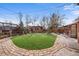 Landscaped backyard with green lawn and custom shed and brick pathway at 10874 Pearl Ct, Northglenn, CO 80233