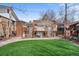 Backyard featuring lattice covered patio area, water feature, and well-maintained lawn at 10874 Pearl Ct, Northglenn, CO 80233