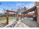 Backyard featuring a covered patio area, shed, and well-maintained lawn with brick pathway at 10874 Pearl Ct, Northglenn, CO 80233