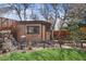 Backyard with a garden shed, custom water feature, and manicured lawn at 10874 Pearl Ct, Northglenn, CO 80233
