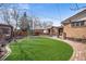 Spacious backyard featuring lush grass and a cozy pergola area for outdoor entertaining at 10874 Pearl Ct, Northglenn, CO 80233