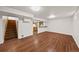 Spacious basement area with wood flooring and stairs, ideal for recreation or storage at 10874 Pearl Ct, Northglenn, CO 80233