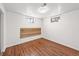 Bedroom with hardwood floors, white walls, and windows for natural light at 10874 Pearl Ct, Northglenn, CO 80233