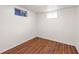 Cozy bedroom boasts wood flooring and windows that offer natural light at 10874 Pearl Ct, Northglenn, CO 80233