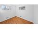 Empty bedroom with hardwood floors, two windows, and natural light at 10874 Pearl Ct, Northglenn, CO 80233