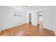 Empty bedroom with hardwood floors, natural light, and a closet at 10874 Pearl Ct, Northglenn, CO 80233