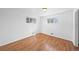 Empty bedroom with hardwood floors and natural light, offering a versatile space at 10874 Pearl Ct, Northglenn, CO 80233