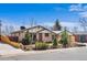 A well-maintained one-story home with a brick facade, mature landscaping, and a cozy front porch at 10874 Pearl Ct, Northglenn, CO 80233