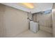 Basement laundry area with a washing machine and exposed concrete walls at 10874 Pearl Ct, Northglenn, CO 80233