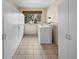 Spacious laundry room with a window, storage cabinets, and washer and dryer at 10874 Pearl Ct, Northglenn, CO 80233