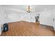 Open-concept living room with light hardwood floors flowing into the kitchen at 10874 Pearl Ct, Northglenn, CO 80233