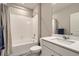 Bright bathroom featuring a shower-tub combination with tiled surround and a vanity with a modern sink at 14758 Normande Dr, Mead, CO 80542