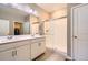 Modern bathroom featuring double sinks, a walk-in shower with glass door, and neutral color palette at 14758 Normande Dr, Mead, CO 80542
