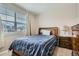 Comfortable bedroom with a large window offering natural light, and classic wood furniture at 14758 Normande Dr, Mead, CO 80542