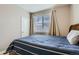 Inviting bedroom bathed in natural light, featuring wood accents and plush carpet at 14758 Normande Dr, Mead, CO 80542