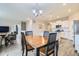 Cozy dining area with dark wood table and chairs, open to the living room and kitchen at 14758 Normande Dr, Mead, CO 80542