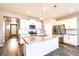 Bright kitchen featuring white cabinets, stainless steel appliances, and a large center island at 14758 Normande Dr, Mead, CO 80542