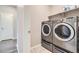 Convenient laundry area showcasing stainless steel washer and dryer set with ample space for chores at 14758 Normande Dr, Mead, CO 80542