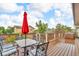 Spacious back deck with an outdoor dining set and a relaxing hot tub, perfect for entertaining at 9816 Kalispell St, Commerce City, CO 80022
