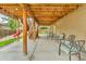Covered backyard patio featuring comfortable seating and an open space, great for outdoor gatherings at 9816 Kalispell St, Commerce City, CO 80022