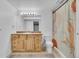 Bathroom with neutral color cabinets, sink, toilet and walk in shower at 9816 Kalispell St, Commerce City, CO 80022