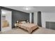 Cozy bedroom with a queen bed, nightstands, and a bathroom entrance is ready to move in at 9816 Kalispell St, Commerce City, CO 80022