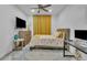 Cozy bedroom featuring ceiling fan, and a floral patterned bedspread with matching curtains at 9816 Kalispell St, Commerce City, CO 80022
