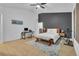 Modern bedroom with a ceiling fan, exercise bike, a work area, and a bench at 9816 Kalispell St, Commerce City, CO 80022
