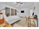 Bedroom with neutral decor, large windows, and a dedicated workspace with a desk and chair at 9816 Kalispell St, Commerce City, CO 80022