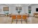 Elegant dining room with stylish chandelier, large windows, and hardwood floors at 9816 Kalispell St, Commerce City, CO 80022