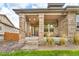 Inviting covered front porch with brick pillars and neutral paint scheme enhance the home's curb appeal at 9816 Kalispell St, Commerce City, CO 80022