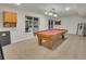 Recreation room with a pool table, natural light, and comfortable carpeting at 9816 Kalispell St, Commerce City, CO 80022