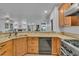 Kitchen features stainless steel appliances, custom cabinetry, and granite countertops at 9816 Kalispell St, Commerce City, CO 80022