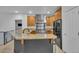 Kitchen boasts stainless steel appliances, granite countertops, and custom cabinetry at 9816 Kalispell St, Commerce City, CO 80022