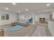 Open-concept living space with a bar, seating area, and bright lighting at 9816 Kalispell St, Commerce City, CO 80022