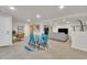 Expansive living area with a dining table, office area, and a comfortable seating arrangement at 9816 Kalispell St, Commerce City, CO 80022