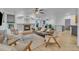 Bright living room features hardwood floors, a fireplace, a ceiling fan, and comfortable seating at 9816 Kalispell St, Commerce City, CO 80022
