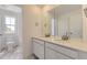 Bathroom featuring dual sinks, modern vanity, and a shower/tub combo at 2968 S Poppy St, Morrison, CO 80465
