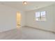 Bright bedroom with neutral carpet, a window, and an ensuite bathroom at 2968 S Poppy St, Morrison, CO 80465