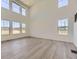 Bright and airy living room featuring high ceilings, large windows, and wood-look flooring at 2968 S Poppy St, Morrison, CO 80465