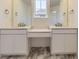 Main bathroom with dual vanities, marble-look floor, and modern fixtures at 2968 S Poppy St, Morrison, CO 80465