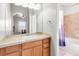 Bright bathroom with white cabinets, tile shower, and large mirror offers a clean and functional space at 13181 Grant W Cir # B, Thornton, CO 80241