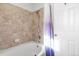 Neat bathroom featuring tiled shower and bathtub, providing an accessible and functional space at 13181 Grant W Cir # B, Thornton, CO 80241