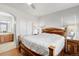 Spacious bedroom with wood accents, soft lighting, and adjoining bathroom provides a comfortable retreat at 13181 Grant W Cir # B, Thornton, CO 80241
