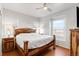 Cozy bedroom featuring a wood-framed bed, hardwood floors, and natural light from the windows at 13181 Grant W Cir # B, Thornton, CO 80241
