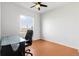 Bedroom with laminated floors, bright light, and a dedicated desk space with a black chair at 13181 Grant W Cir # B, Thornton, CO 80241